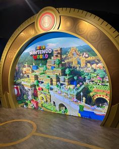 the entrance to mario's world is decorated in gold and blue with an image of a town on it