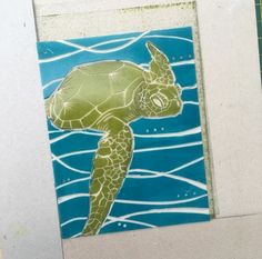 a green sea turtle swimming in the ocean with blue water and waves on it's back