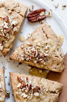 several pieces of pie on a plate with pecans