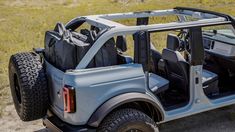 a gray jeep with its doors open in the desert