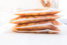 four pieces of bread stacked on top of each other in front of a white table