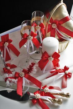 red and white wedding garters, wine glasses and champagne flutes on a table