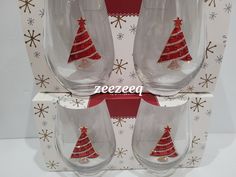 three wine glasses with red and gold christmas trees on them