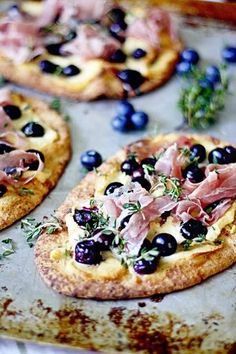 two small pizzas with toppings on them