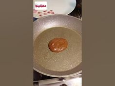 a frying pan filled with food on top of a stove