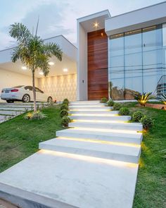 a modern house with white steps leading to the front door