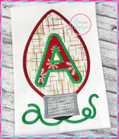 an applique with the letter a on it is shown in red, green and white