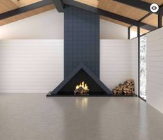 a room with a fire place in the middle and wood stacked up on the floor