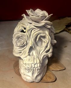 a white skull with flowers on it's head