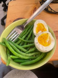 green beans and eggs in a bowl with a fork