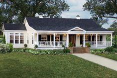 a white house with black roof and front porch