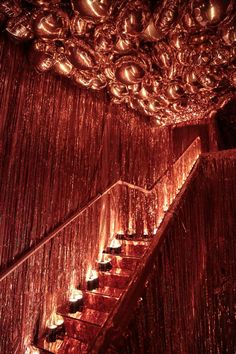 the stairs are covered in red tinsel and lit with candles for a festive effect