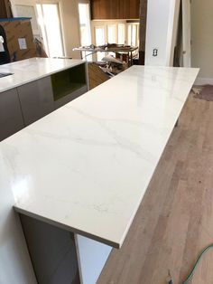 an unfinished kitchen counter top in the process of being installed by a professional installer