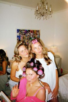 three young women are posing for the camera