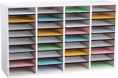 a white bookcase filled with lots of different colored papers and folders on top of each other