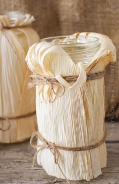 two vases made out of wood sitting on top of a wooden table