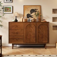 a living room with wooden furniture and pictures on the wall