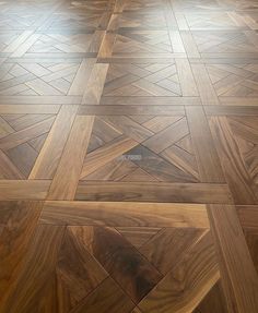 the floor is made up of wood planks and has been polished with an interesting pattern