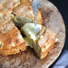 a piece of bread with butter on it is being cut into pieces by a knife