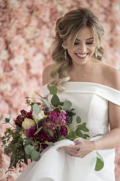 a woman in a wedding dress holding a bouquet