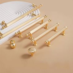 gold hardware and knobs on a beige background