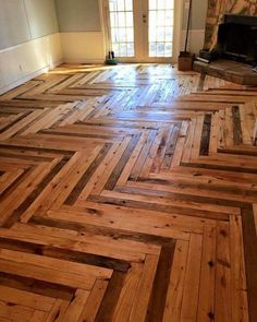 an empty room with wood flooring in it