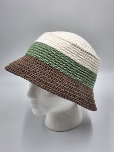 a white mannequin head wearing a multicolored crochet sun hat