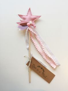 two toothbrushes with pink and white flowers on them next to a brown tag