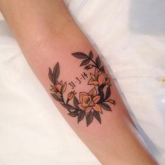 a woman's arm with flowers on it and the words happy written in cursive writing