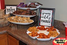 there are many different types of food on the counter in this kitchen, including donuts and other snacks