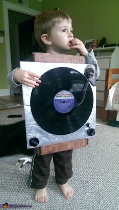 a little boy that is standing in front of a record