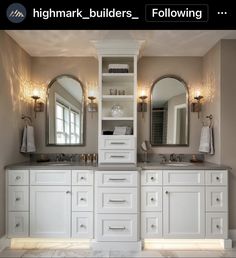 a bathroom with double sinks and two mirrors on the wall next to eachother