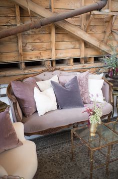 a living room filled with furniture and lots of pillows