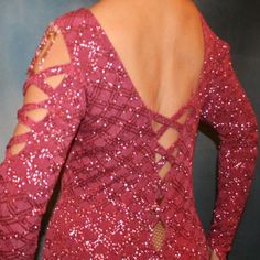 the back of a woman's red dress with cutouts and sequins