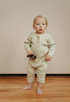 Casual Ribbed Onesie, Casual Ribbed Onesie For Loungewear, Ribbed Cotton Onesie For Loungewear, Casual Beige Bubble Romper For Playtime, Casual Cream Onesie For Playtime, Cream Casual Onesie For Playtime, Solid Onesie For Playtime In Fall, Beige Long Sleeve Onesie For Playtime, Casual Cream Onesie For Loungewear