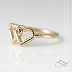 Two hearts combined can create infinite love! This ring has two interlocking hearts, fused together as one. A perfect symbol of love and commitment. The band is round and smooth and about 1.3mm wide. The two hearts are about 7.5mm tall. These rings are all solid, no plating. The fourth and fifth pictures shows the ring in solid 14k rose gold. This ring is made to order in your size and choice of metal. Please select from the options available and allow 1-2 weeks for your ring to be finished. Che Minimalist Double Heart Anniversary Rings, Classic Open Heart Ring For Promise, Adjustable Double Heart Rings For Wedding, Elegant Open Heart Stackable Promise Rings, Adjustable Double Heart Wedding Rings, Elegant Stackable Rings With Open Heart For Promise, Elegant Stackable Open Heart Rings For Promise, Elegant Stackable Open Heart Promise Rings, Elegant Adjustable Open Heart Stackable Rings