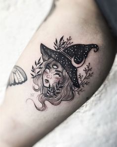 a woman with a hat on her head and butterflies around her neck is depicted in this tattoo design