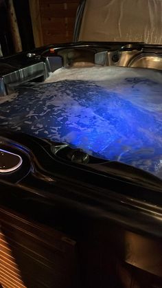 a hot tub with water in it sitting on top of a table