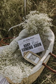 a basket filled with baby's breath next to a sign on top of it