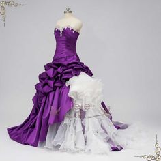 a purple and white wedding dress on display