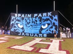 a large banner on the side of a football field