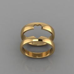 two gold wedding rings on a grey background