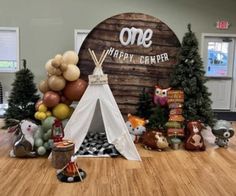 there is a teepee tent with balloons on it and other decorations in the background