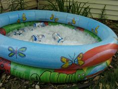 an inflatable swimming pool filled with ice and water, sitting on the ground