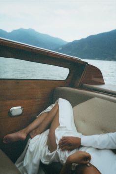 a woman laying on the back of a boat