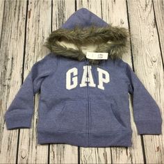 This Is A Nice Sweatshirt That Zips Up The Front For A Girl Done In Blue With An Iridescent & Silver Gap Logo On The Chest. The Body Of The Garment Is Lined With A Very Soft Fleece & Has A Faux Fur Lined Hood. New With Tags. Blue Hooded Top For Playtime, Winter Hoodie Sweatshirt For Playtime, Fleece Hoodie For Playtime, Blue Winter Sweatshirt For Playtime, Gap Blue Long Sleeve Outerwear, Cute Gap Cotton Outerwear, Cute Cotton Outerwear By Gap, Cute Gap Outerwear For Fall, Winter Hooded Sweatshirt By Gap