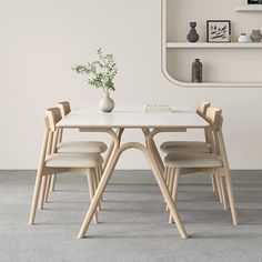 a white table with four chairs around it