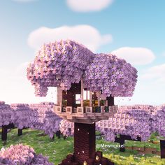 a tree house in the middle of a field with purple flowers on it's branches