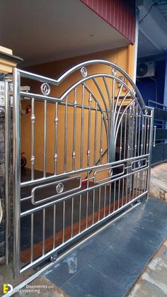 an iron gate is open to allow people to enter the building or into the yard