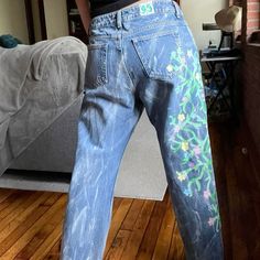 This pair was the second pair of jeans I ever painted!  There was a lot of trial and error, but the challenges only enriched my experience. I fell in love with these jeans, the vines and flowers are so beautiful!

They're size 12, hand-painted, high-waisted, and straight legged. For reference, the model is 5'7 and size 4 in ae jeans. These jeans have a low waisted, bf fit on her. In terms of flaws there is some wearing on the jeans but that is all.

Measurements
Waist 30”
Hips 41”
Rise 11”
Insea Artistic Cotton Jeans For Summer, Hand Painted Straight Leg Jeans For Spring, Hand Painted Casual Bottoms For Spring, Artistic Straight Leg Denim Jeans, Artistic Denim Jeans For Summer, Spring Hand Painted Straight Leg Jeans, Artistic Summer Denim Jeans, Trendy Hand Painted Blue Jeans, Hand Painted Straight Leg Cotton Jeans